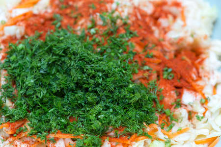 finely chopped green dill on the surface of coleslawの写真素材