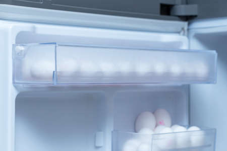 chicken eggs on a plastic tray in the fridgeの写真素材