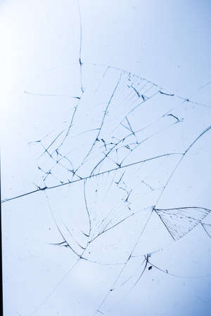 Broken glass on blue background, object background design textureの写真素材