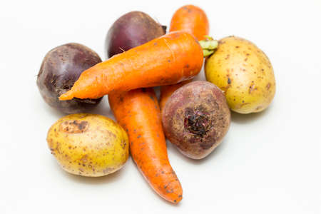 potatoes, beets and carrots on a white backgroundの写真素材