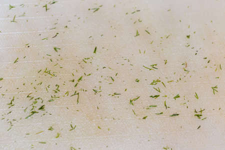 background, finely chopped green dill on a kitchen boardの写真素材