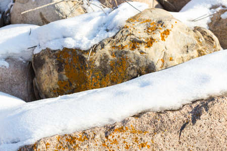 huge stones in the snow of different shapes and sizes, natural stone, winter backgroundの写真素材