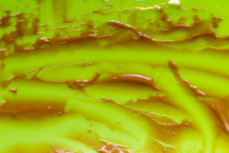 traces of remaining chocolate cream on a green backgroundの写真素材