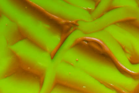 traces of remaining chocolate cream on a green backgroundの写真素材