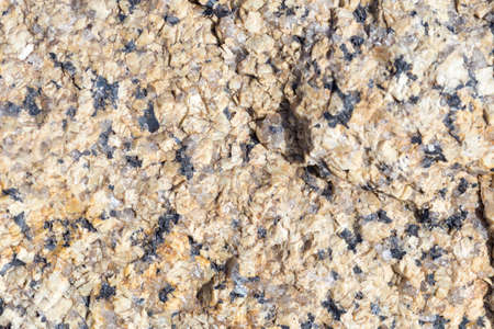 Stone surface of a dark yellow sandstone, background, textureの写真素材