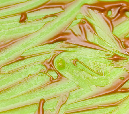 traces of remaining chocolate cream on a green backgroundの写真素材