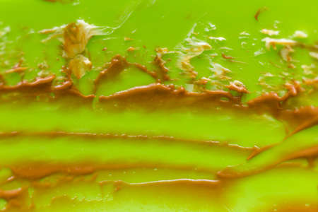 traces of remaining chocolate cream on a green backgroundの写真素材