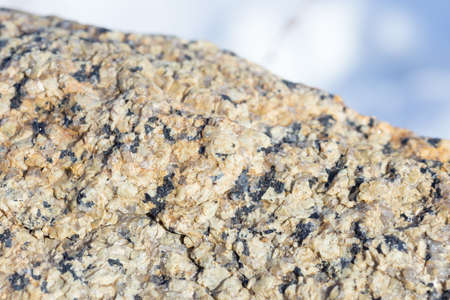 Stone surface of a dark yellow sandstone, background, textureの写真素材