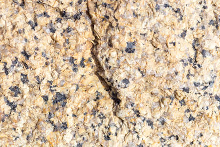Stone surface of a dark yellow sandstone, background, textureの写真素材
