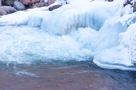 Mountain river and stones in winterの写真素材