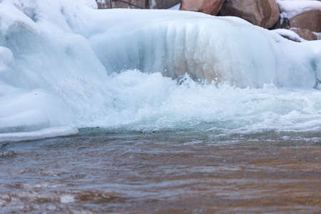 Mountain river and stones in winterの写真素材