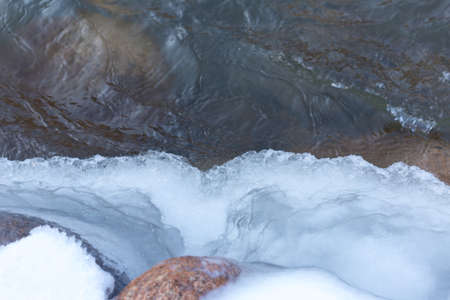 stone on ice in a frozen lakeの写真素材