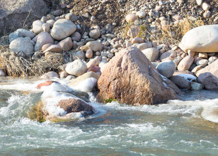 Mountain river and stones in winterの写真素材