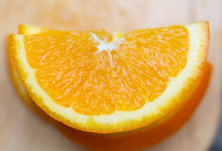 piece of tangerine on a wooden tableの写真素材