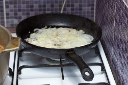 onion fried in a frying panの写真素材