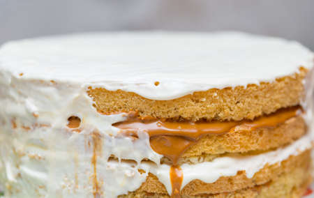 application of milk cream on the surface of the sweet cakeの写真素材