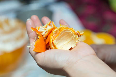orange peel in handsの写真素材
