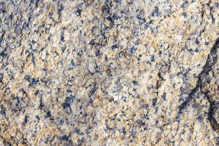 Stone surface of a dark yellow sandstone, background, textureの写真素材