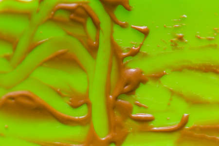 traces of remaining chocolate cream on a green backgroundの写真素材