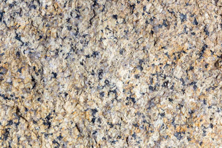 Stone surface of a dark yellow sandstone, background, textureの写真素材