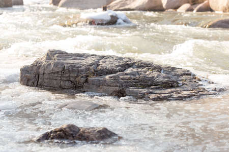 Mountain river and stones in winterの写真素材
