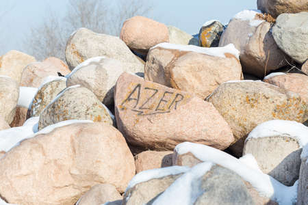 huge stones in the snow of different shapes and sizes, natural stone, winter backgroundの写真素材