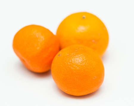three tropical oranges on a white backgroundの写真素材