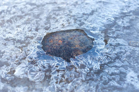 stone on ice in a frozen lakeの写真素材
