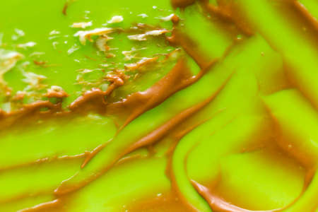 traces of remaining chocolate cream on a green backgroundの写真素材