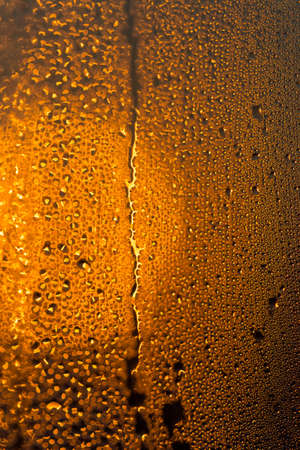water drops on the glass surface at sunset, macroの写真素材