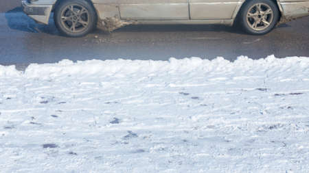 car drives in the winter on a dirty roadの写真素材