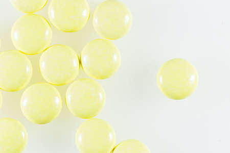 Yellow pill or capsule on background with copy space Prescription for medicines Medicines in healthy containers antibiotics on white backgroundの写真素材