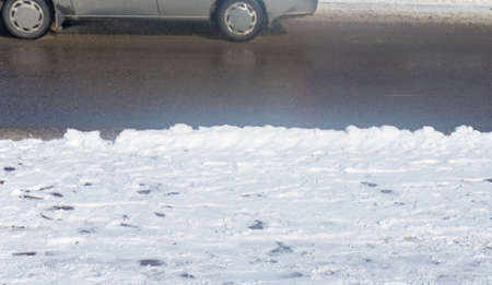 car drives in the winter on a dirty roadの写真素材
