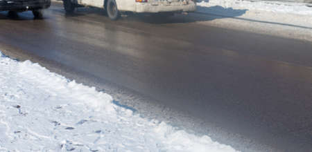 car drives in the winter on a dirty roadの写真素材