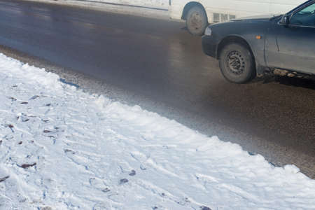 car drives in the winter on a dirty roadの写真素材