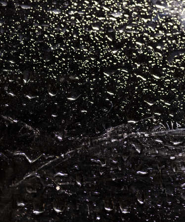 water drop on black . macro close up .raining glass isolated black backgroundの写真素材