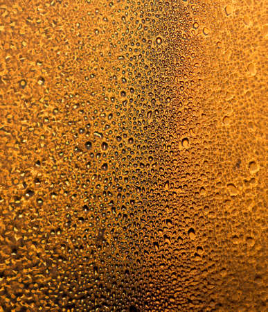 water drops on the glass surface at sunset, macroの写真素材