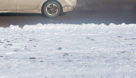 car drives in the winter on a dirty roadの写真素材