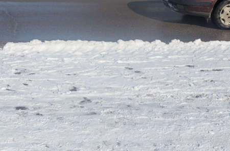 car drives in the winter on a dirty roadの写真素材