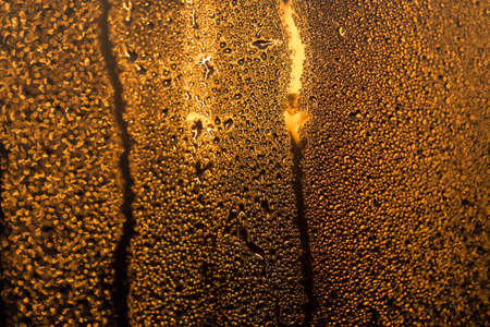 water drops on the glass surface at sunset, macroの写真素材
