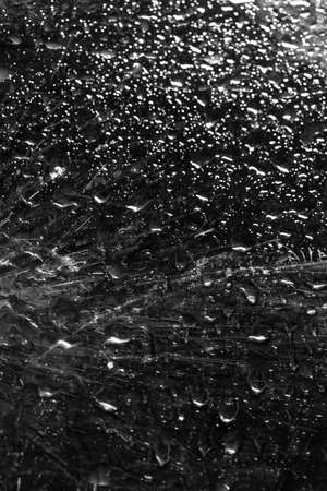 water drop on black . macro close up .raining glass isolated black backgroundの写真素材