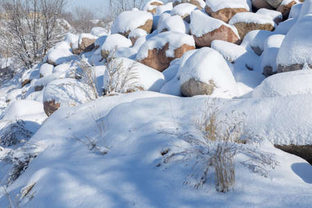 Winter landscape with snow-covered stones.の写真素材