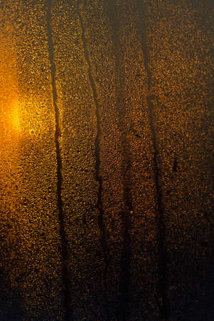 water drops on the glass surface at sunset, macroの写真素材