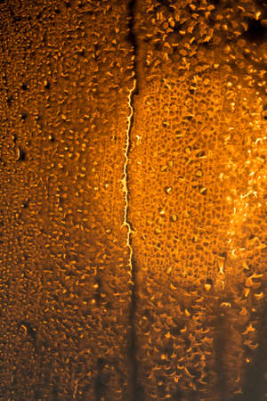 water drops on the glass surface at sunset, macroの写真素材