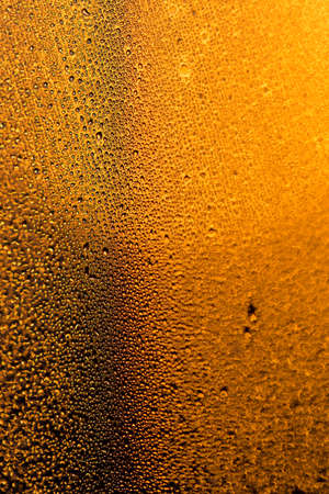 water drops on the glass surface at sunset, macroの写真素材