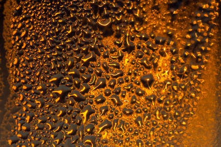 water drops on the glass surface at sunset, macro