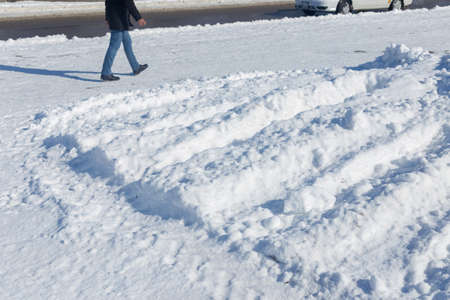 The steps of a man in a snowy winter landscape with lots of snow, a man heads, leaving behind the stepsの写真素材
