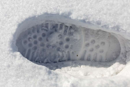 traces of shoes on a background of snowの写真素材