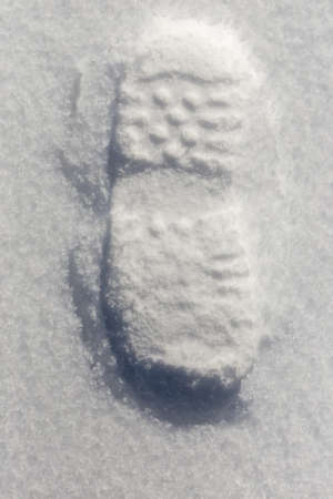 traces of shoes on a background of snowの写真素材