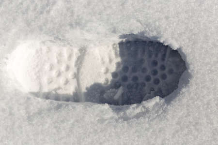 traces of shoes on a background of snowの写真素材